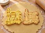 Butter-gelber Ausstecher mit Prägung mit Springer, Turm, König und liegendem Bauern neben gebackenem Keks mit geprägter Mähne auf hellem Holz